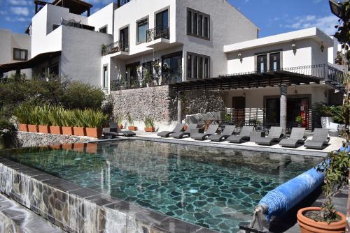 a swimming pool in front of a house at Casa Itzae La Antigua Dog Friendly in San Miguel de Allende