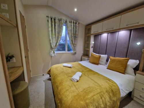a bedroom with a large bed and a window at Beautiful Caravan near Edinburgh nr 9 in Port Seton