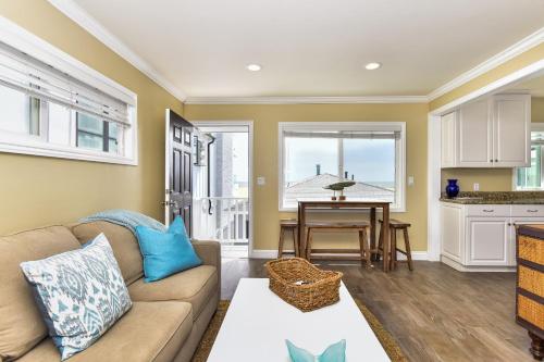 a living room with a couch and a table at Oceanfront Back Home with View of the Sea in Newport Beach