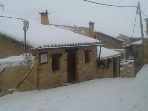 a building with snow on the roof of it at Mirador del Maestrazgo in Ejulve