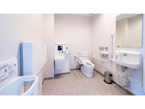 a bathroom with two toilets and two sinks at Hotel Torifito Miyakojima Resort - Vacation STAY 79478v in Miyako Island