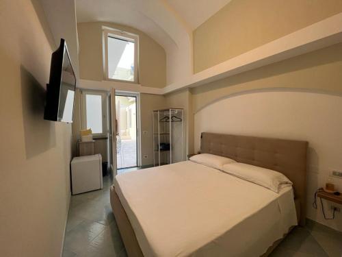 a bedroom with a bed and a television in it at Palazzo Palumbo in Procida