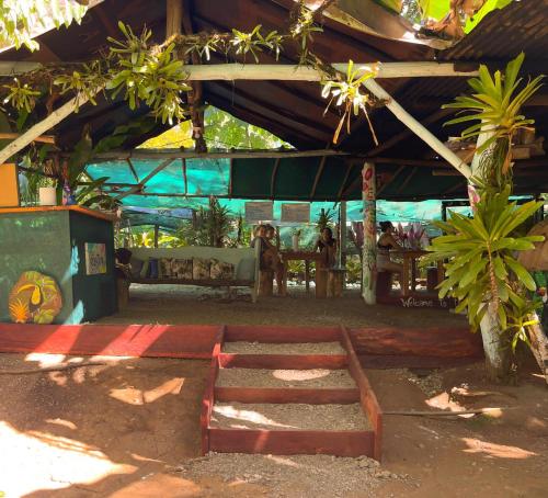 a patio with a table and chairs and a tent at Rio Agujitas Eco-Jungle in Drake
