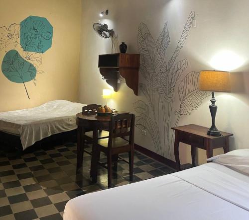 a hotel room with a bed and a table with a lamp at ViaVia Leon in León