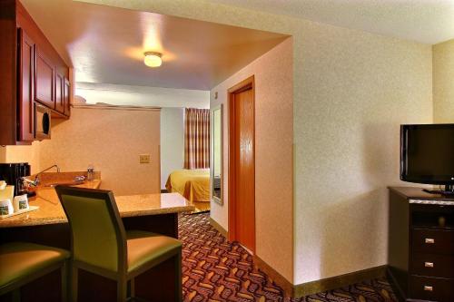 a hotel room with a desk and a room with a television at Mansfield Hotel in Mansfield