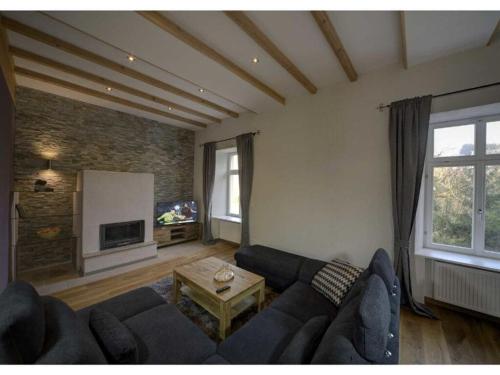 a living room with a couch and a table at Holiday apartment Goose in the monument in Maring-Noviand