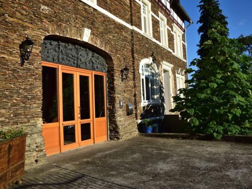an entrance to a brick building with an orange door at Holiday apartment Goose in the monument in Maring-Noviand