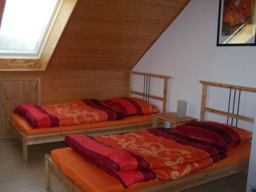 two beds in a room with a attic at Schwedenhaus Grüner Weg in Burg auf Fehmarn