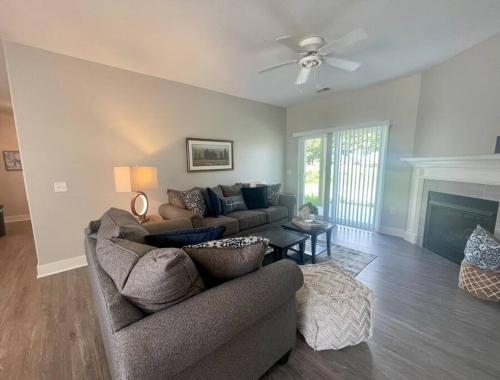 a living room with a couch and a fireplace at Main Floor 2 Bedroom Condo in Bettendorf in Bettendorf