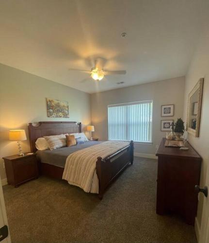 a bedroom with a bed and a ceiling fan at Main Floor 2 Bedroom Condo in Bettendorf in Bettendorf