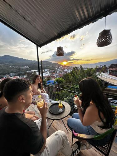 a group of people sitting around a table on a balcony at Urban Hostal San Gil- Piscina Restaurante Bar in San Gil