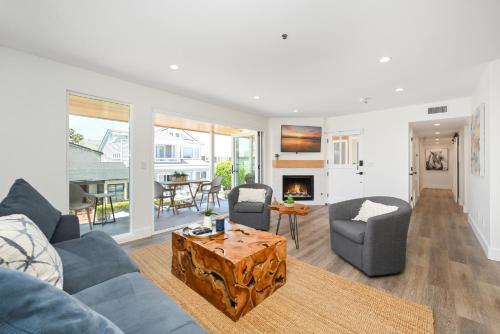 a living room with a couch and chairs and a table at Perfect Renovated and Modern Duplex on Balboa Island in Newport Beach