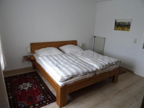 a bedroom with a bed in a room with a rug at Ferienwohnung Dorothea in Kulmbach