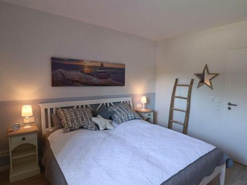 a bedroom with a bed and a ladder and a star on the wall at Holiday apartment SeaSide in Westerbergen