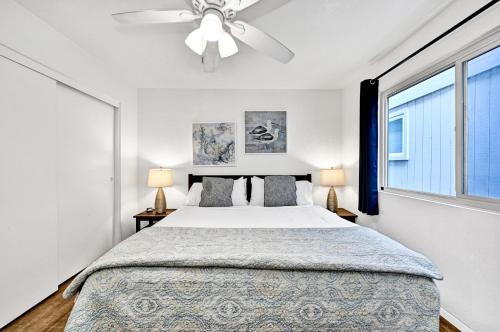 a bedroom with a bed and a ceiling fan at Charming 1-Bedroom Home on 29th Street in Newport Beach