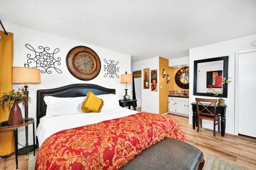 a bedroom with a large bed and a desk at Spanish Castle By The Sea in Newport Beach in Newport Beach