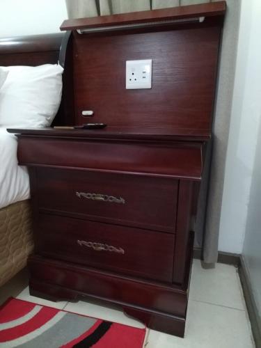 a mahogany dresser with a dark wooden drawer at Cheers in Evander