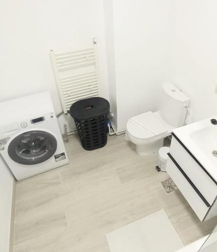 a bathroom with a washing machine and a toilet at CLASSY 2-Dormitoare in Baia Mare