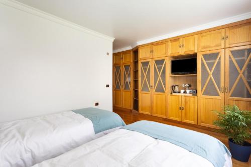 a bedroom with a bed and wooden cabinets at Casa Lali Habitación 2 in La Laguna