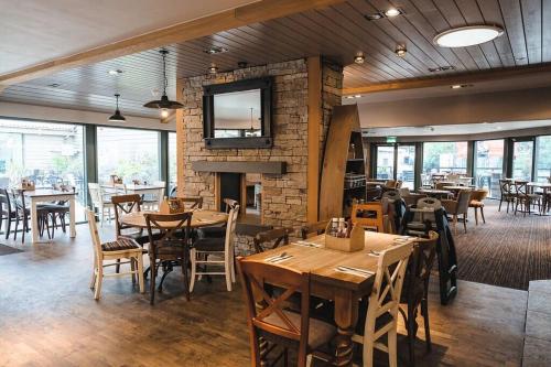 a restaurant with tables and chairs and a fireplace at Beautiful Caravan near Edinburgh nr 9 in Port Seton