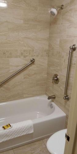 a bathroom with a white tub and a toilet at Best Western Plus Otonabee Inn in Peterborough