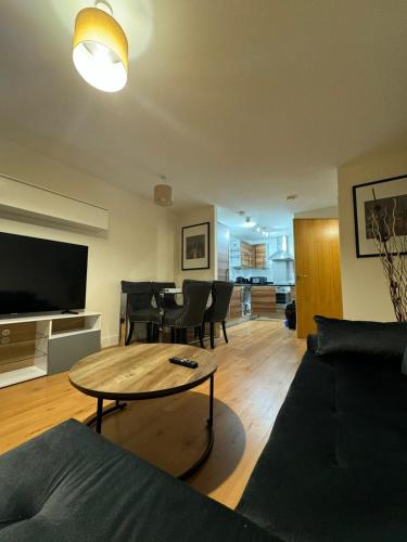 a living room with a couch and a table at Bermondsey by Tower Bridge in London