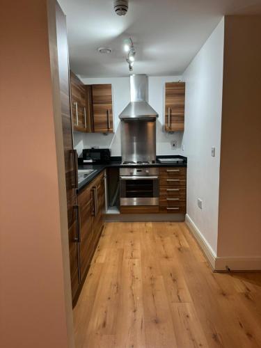a kitchen with wooden floors and a stove top oven at Bermondsey by Tower Bridge in London