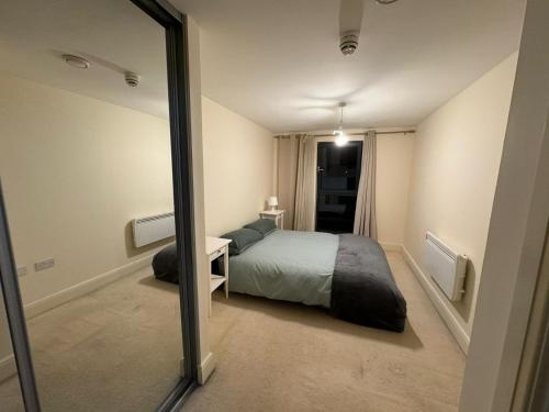 a bedroom with a bed and a mirror at Bermondsey by Tower Bridge in London