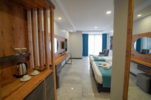 a hotel room with a bed and a couch at Çelik Thermal & Spa in Pamukkale
