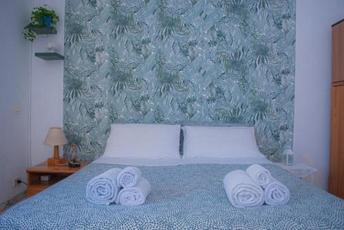 a bed with white towels on top of it at Villa Magnolia con giardino in Bari