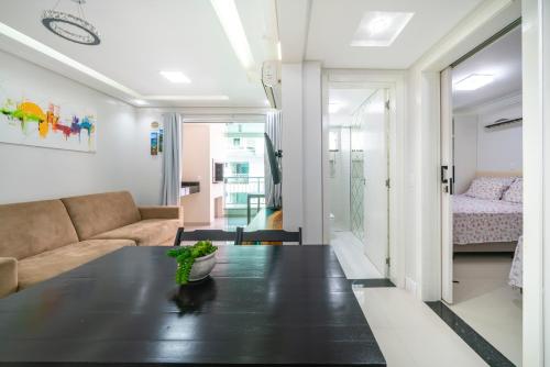 a living room with a table and a couch at Bombinhas Summer Beach APT 333 in Bombinhas
