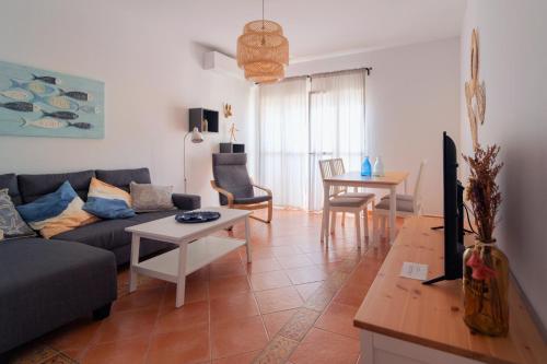 a living room with a couch and a table at Apartamento Atardeceres in Ayamonte