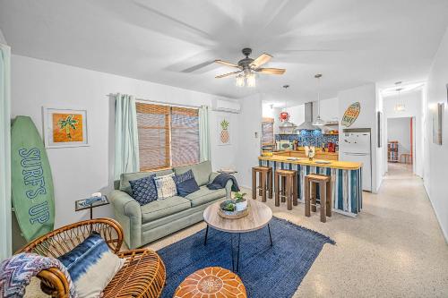 a living room with a couch and a table at Beachside Bliss 1 miles to the beach with heated pool in Sarasota