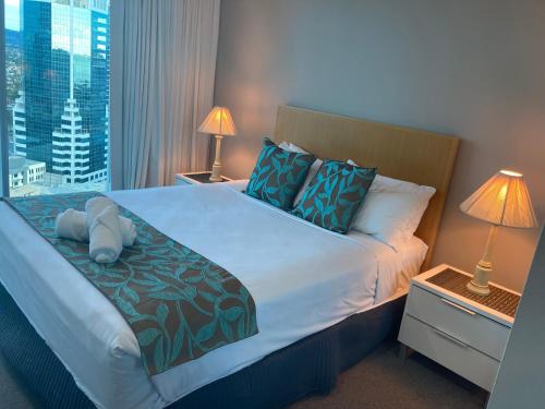 a bedroom with a large bed with a view of a city at Spectacular 19th Floor Apartment in Heart of Surfers Paradise in Gold Coast