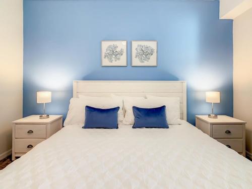 - une chambre bleue avec un lit blanc et 2 oreillers bleus dans l'établissement Gorgeous 2BR lakeview Condo with Waterpark, à Kissimmee