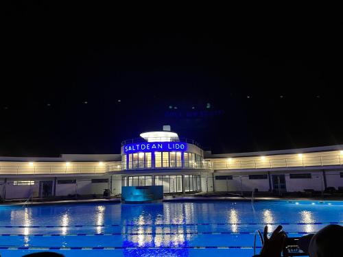 a building with a sign on it at night at Saltdean Stay in Brighton & Hove