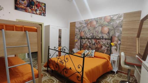 a bedroom with two beds and a painting on the wall at Orange Lemon in Palermo