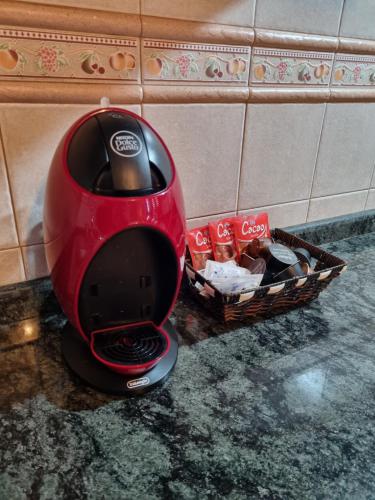 a red toaster sitting on a counter with a basket at CASA PABLITO in San Bartolomé de Tirajana