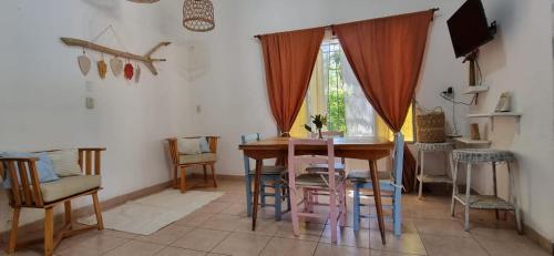 a dining room with a wooden table and chairs at Casa en Paso De La Patria in Paso de la Patria