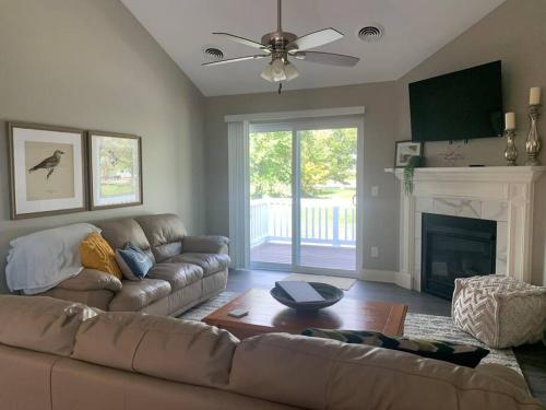 a living room with a couch and a fireplace at Modern 3-bedroom condo with gas fireplace in Bettendorf