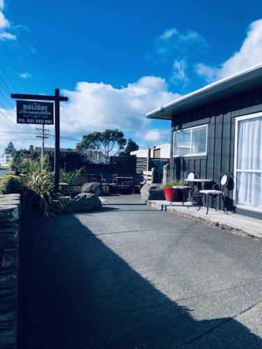 a street sign in front of a building at Clyde Suite in Tauranga