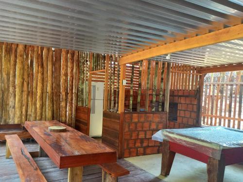 a room with wooden tables and wooden walls at Cabana tucuxi in Novo Airão