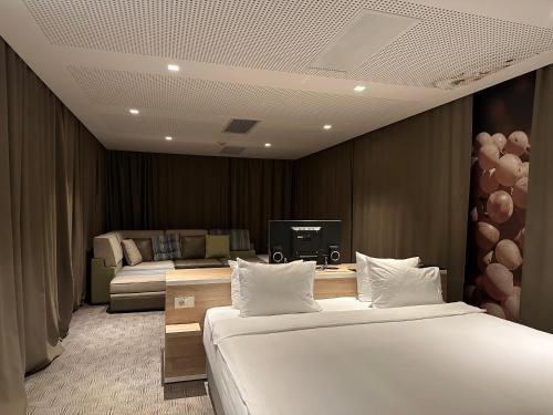 a hotel room with two beds and a television at Hotel Nar in Trebinje