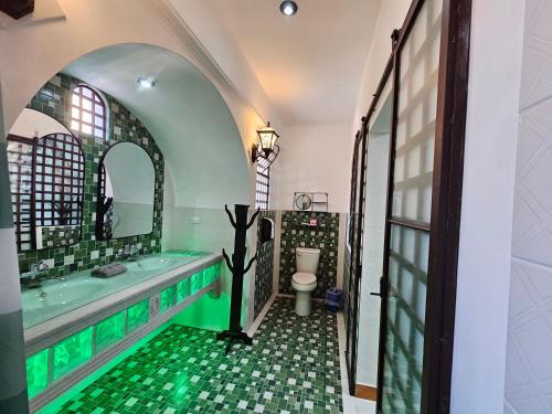 a bathroom with a tub and a sink and a toilet at La Capitanía de San Pedro in Antigua Guatemala