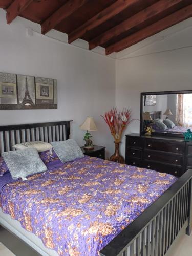 a bedroom with a bed and a dresser and a mirror at Apartamentos Rosarito.!! Con Vista al Mar ! in Rosarito