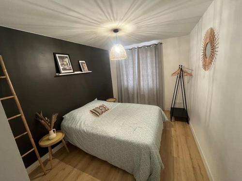 a bedroom with a bed and a ladder and a lamp at T3 Orléans charmant avec parking centre-ville in Orléans