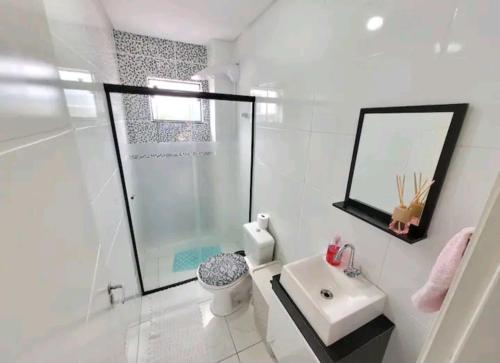 a bathroom with a shower and a toilet and a sink at Apartamento novo e completo! in Brusque
