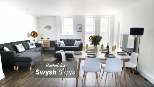 a living room with a table and chairs at 11 Breakwaters Way - Sandown in Sandown