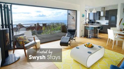 a living room with a view of the ocean at Seagrass - Ventnor in Ventnor