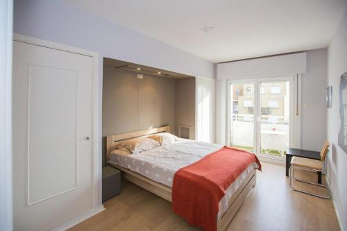 sypialnia z łóżkiem i dużym oknem w obiekcie Bright Apartment With Sea View w Ostendzie